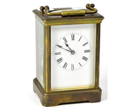 A late 19th/early 20th century French brass carriage clock, the enamelled dial set with Roman numerals, movement striking on 