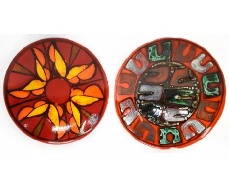 POOLE; two non-matching bowls, a red ground abstract 'Horseshoe' design and one other, diameter of each 27cm (2).