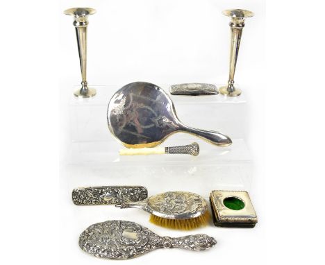 A mixed lot of hallmarked silver items comprising a pair of trumpet form cases, two dressing table mirrors, a brush and comb,