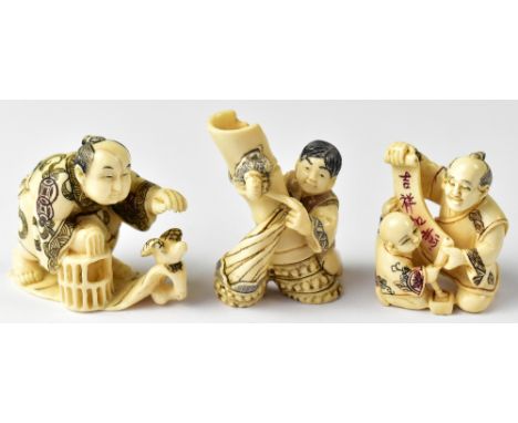 Three Japanese netsuke comprising a man releasing or capturing a bird while holding a cage, a teacher holding up a scroll for