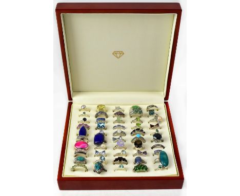 A wooden jewellery ring box containing fifty silver dress rings, various styles, most set with semiprecious stones, to includ