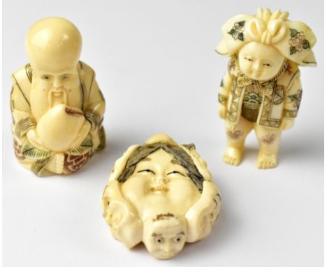 Three Japanese netsuke, one in the form of a double-sided mask surrounded by six masks, and a figure wearing an elaborate hat