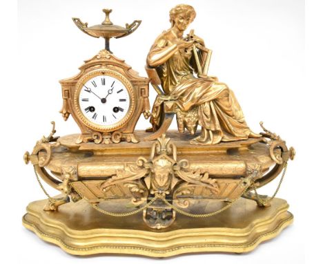A late 19th century Neo-Classical design gilt metal figural mantel clock with Classical lady sat on a bench with harp and scr