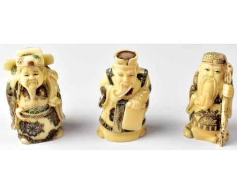Three Japanese netsuke in the form of wise men, one holding a staff, one holding a snake and the other stroking his beard, al
