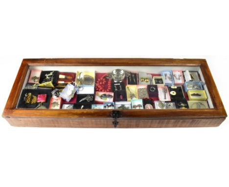 A mahogany rectangular and glazed counter top display case containing over fifty pieces of mainly vintage costume jewellery, 