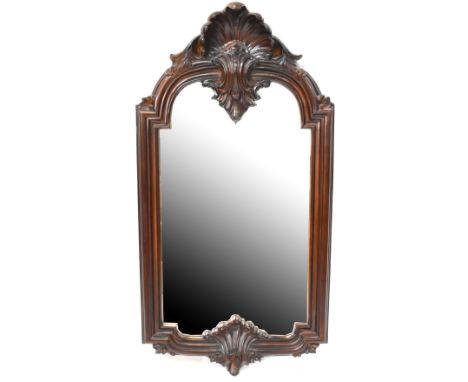 A reproduction mahogany rectangular bevel edged wall mirror with shell decoration to the top of the frame, 113 x 59cm. CONDIT