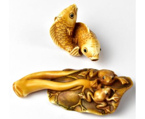 A Japanese netsuke in the form of two frogs sitting on a lily pad and a pair of carp intertwined, both signed, length of long