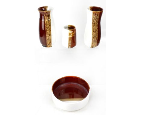 POOLE; a group of four matching ceramic items to include a pair of baluster vases with flared neck, white and brown ground wi