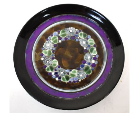 POOLE: a plate in the 'Ionian' pattern by S.M. Pottinger, central raised floral decoration within bands of varying colours bl