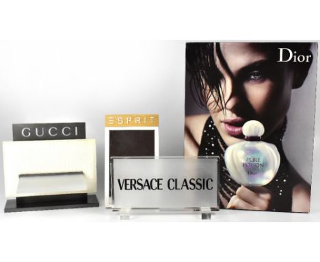 Four shop advertising signs comprising Dior 'Pure Poison' perfume, with image of beautiful young woman holding perfume bottle