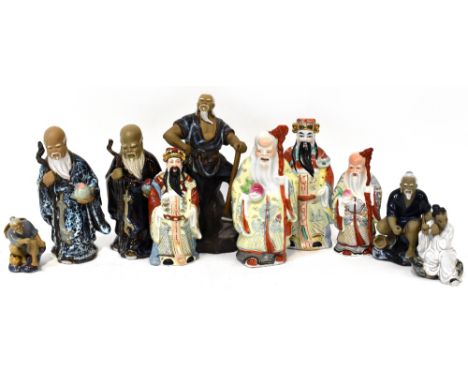 A group of ten 20th century ceramic figures to include a Japanese wood cutter standing on a rocky plinth, two travelling sage