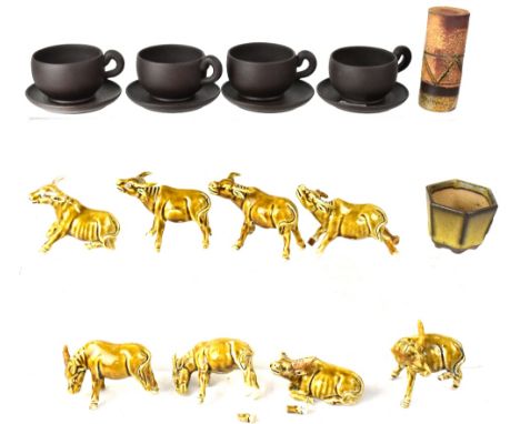 A quantity of ceramic water buffalo, four 20th century Yixing coffee cups and saucers, a small Oriental brush pot and a decor