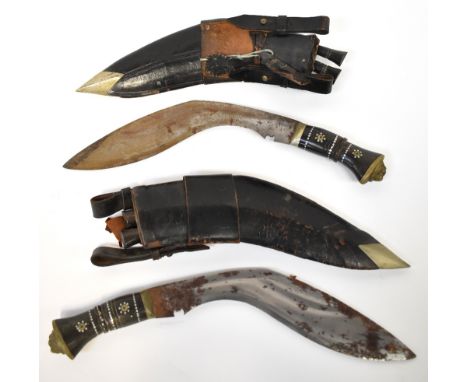 Two identical large kukri knives, with ornate inset wire metal horn handles, with lion mask pommels, leather scabbard with br