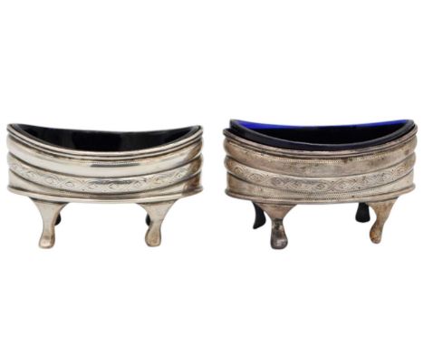 A pair of George III silver boat shaped salts by Solomon Hougham. The lobed banding with bright cut decoration, raised on fou