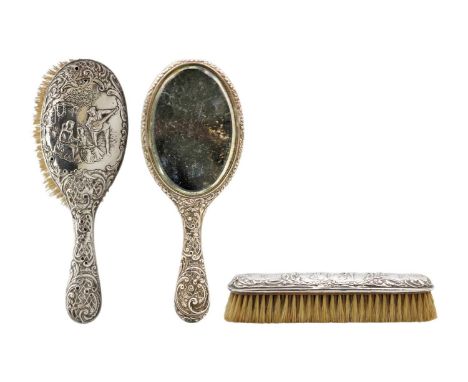 A Victorian silver embossed three-piece dressing table set by Henry Matthews. Each decorated with figural scenes amongst foli