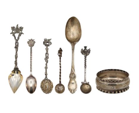 A selection of six silver spoons and a napkin ring. To include a souvenir grapefruit spoon with naturalistic handle and polic