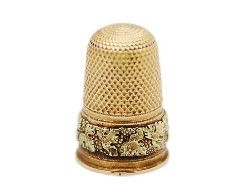 A fine yellow and green gold thimble, (tests 14k) decorated with a band of fruiting vine. Of tall form, length 23mm, 5.9g.