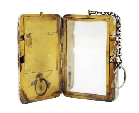 An Edwardian silver gilt combination compact purse by Cohen & Charles. Of planished rectangular form, hinged to reveal a mirr