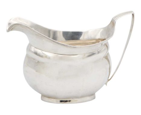 A George III silver cream jug of oval faceted form. Indistinct makers mark, London 1806, width 14.4cm, 3.30 oz.