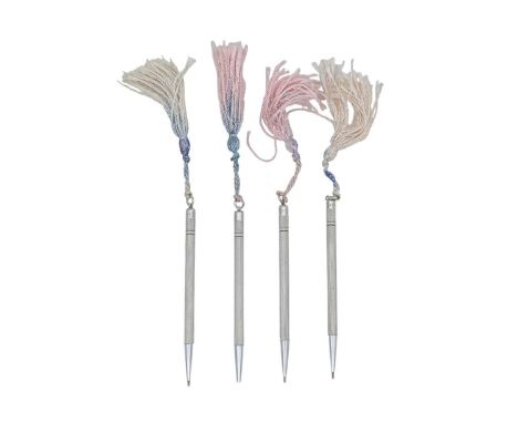 A set of four sterling silver engine turned propelling pencils. Each stamped STERLING SILVER, length 8.5cm.