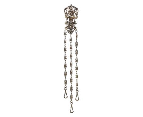 A Victorian silver chatelaine by William Comyns. The clip cast with a nude female and cherubs amongst C scrolls, masks and my