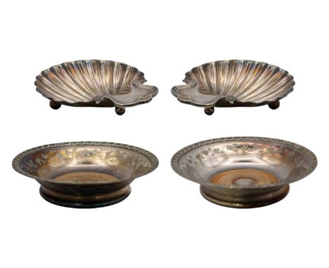 A pair of silver-plated wine coasters and a pair of silver-plated on copper scallop dishes. The coasters with wooden bases, d