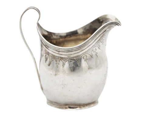 A George III silver cream jug by William Parker. Of helmet form, with bright cut swag and garland decoration, London 1800, he