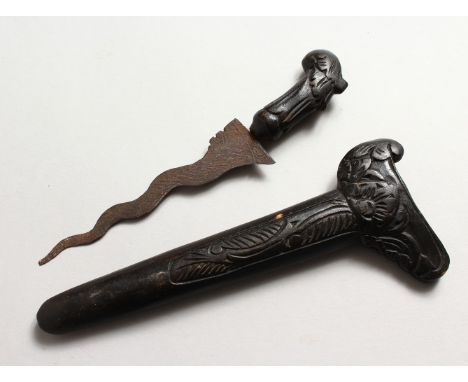 A GOOD 19TH CENTURY INDONESIAN KRIS DAGGER, with a carved wood scabbard, and a carved wood hilt, 23cm overall.