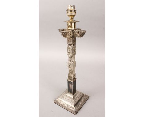 A 19TH CENTURY LARGE SRI LANKAN WHITE METAL CANDLESTICK / LAMP, with carved decoration, possibly silver, 41cm tall x 12cm wid