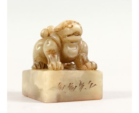 A GOOD 19TH / 20TH CENTURY CHINESE CARVED JADE LION DOG SEAL, the seal carved to depict a seated lion dog, the base carved wi