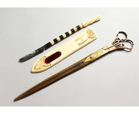 THREE TURKISH OTTOMAN CALLIGRAPHY TOOLS, consisting of a large pair of gold inlaid scissors, 27cm long, a carved ivory makta 