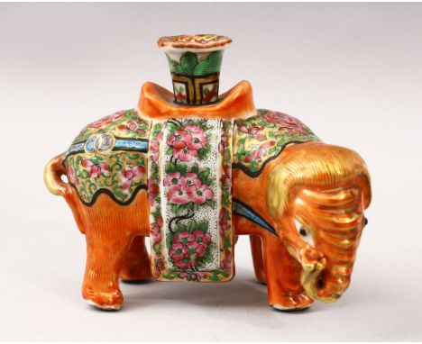 A GOOD 19TH CENTURY CHINESE CANTON FAMILLE ROSE PORCELAIN JOSS STICK HOLDER OF AN ELEPHANT, he elephant in a grazing pose, th