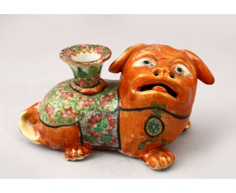 A GOOD 19TH CENTURY CHINESE CANTON FAMILLE ROSE PORCELAIN JOSS STICK HOLDER, in the form of a recumbent dog, the stick holder