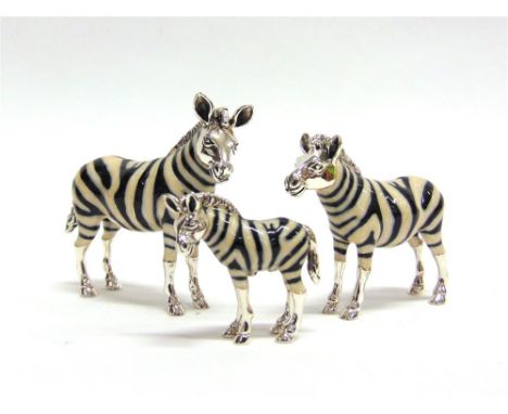 A GRADUATED SET OF THREE SATURNO SILVER AND ENAMEL ZEBRA,  the largest approx 5cm high