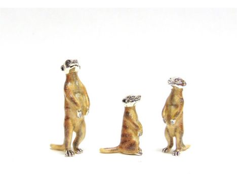 A GRADUATED SET OF THREE SATURNO SILVER AND ENAMEL MEERKAT,  the largest approx 5.5cm high