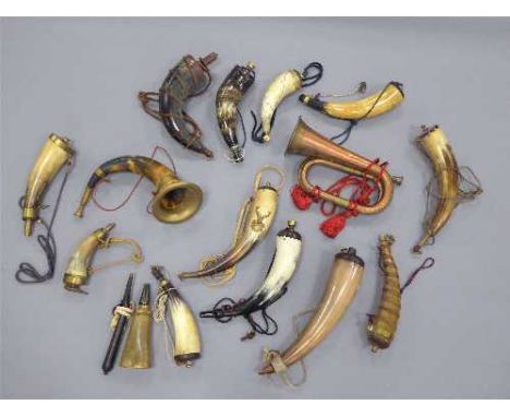 A collection of fourteen horn powder flasks, together with a horn bugle and a copper and brass military bugle. (16)