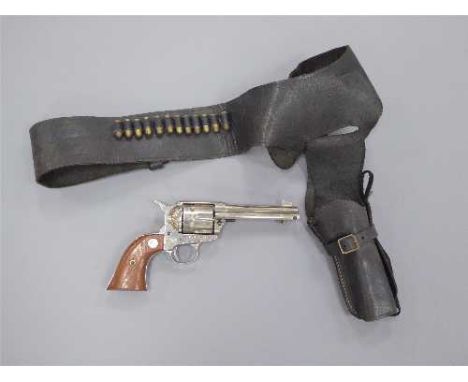 A replica Colt Single Action Army revolver, with leather holster and dummy rounds.