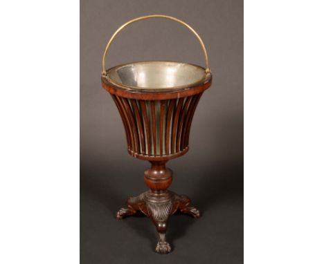 An early 19th century Dutch mahogany jardiniere, flared planter with pierced gallery and liner, urnular pedestal, lotus-cappe