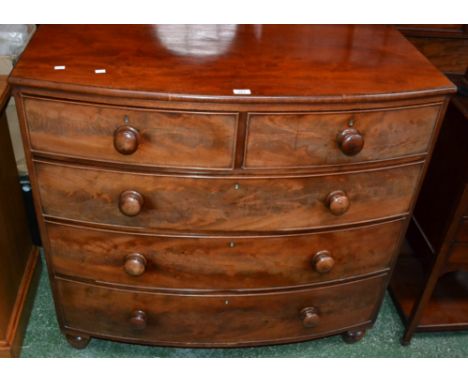 A Victorian flame mahogany bow front chest, two short cockbeaded drawers over three graduated long, button handles, turned fe