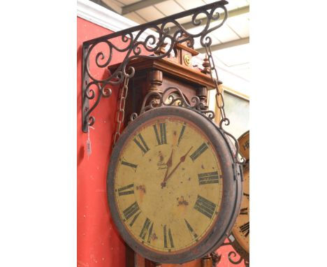 A reproduction platform clock and wrought iron bracket