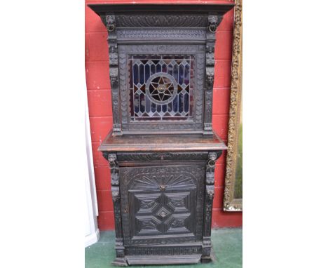A Jacobean revival cabinet, stained glass panel to top cupboard