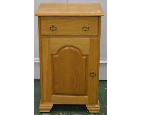 A modern light oak side cabinet, single drawer over fielded panel door cupboard. 92cm high x 55cm wide x 42.5cm deep.