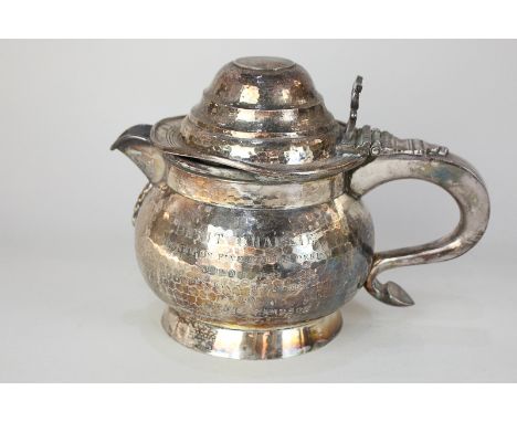 A Chinese white metal teapot with domed lid and scroll handle, engraved armorial and presentation inscription dated 1927, 27o