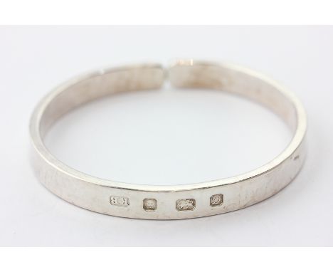 A silver open end bangle