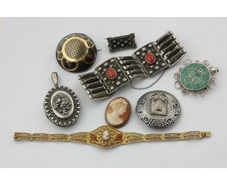 A late Victorian silver locket, a silver and coral bracelet, a filigree silver gilt bracelet set with coral and a shell cameo