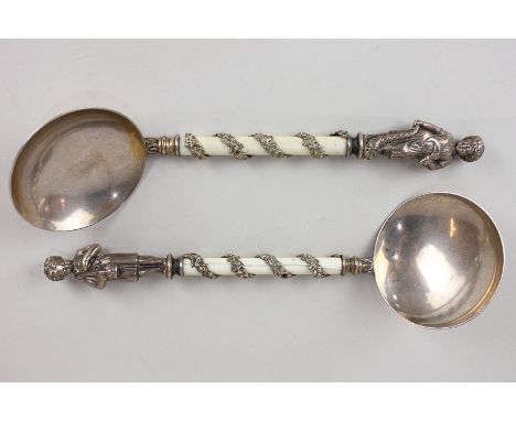 A pair of Victorian silver gilt serving spoons with terminals cast with allegorical figures representing the seasons, ivory h