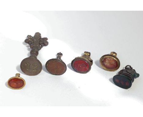 A Georgian gold and cornelian fob seal, two silver seals, and three gilt metal seals