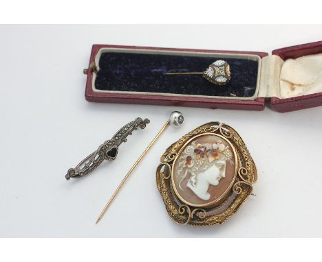 A late Victorian gold shell cameo brooch carved with a Bacchic mask, two stick pins, and a marcasite bar brooch