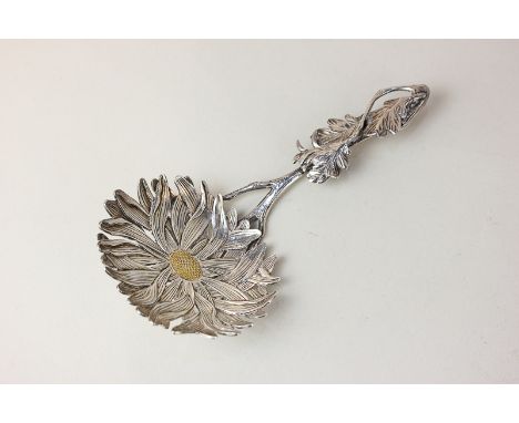 Liberty and Co, a silver caddy spoon, the bowl in the form of a chrysanthemum with a gold centre, on a cast leaf and stem han