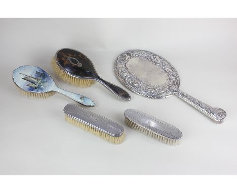 A Victorian silver backed dressing table hand mirror  embossed with cupids and shells, birds and scrolls, London 1883, 33cm, 